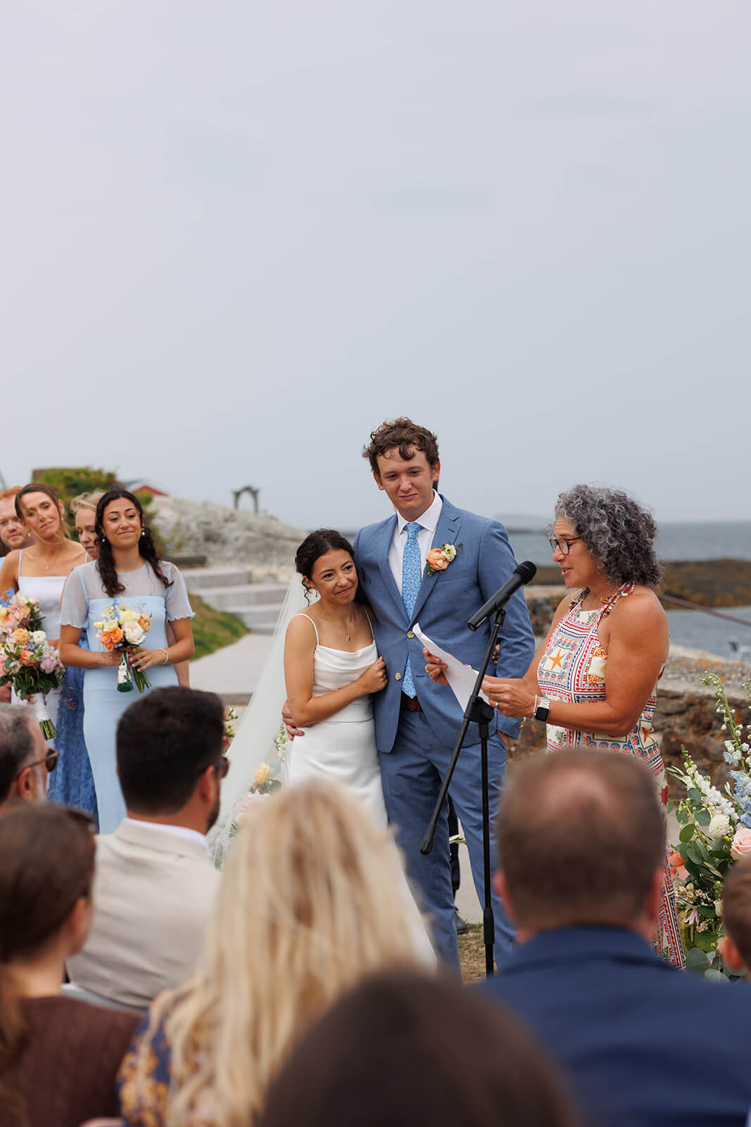 Family member giving a heartfelt speech during a waterfront micro wedding ceremony in coastal Maine.